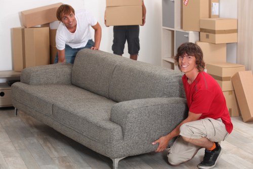 Two movers lifting a heavy item with care